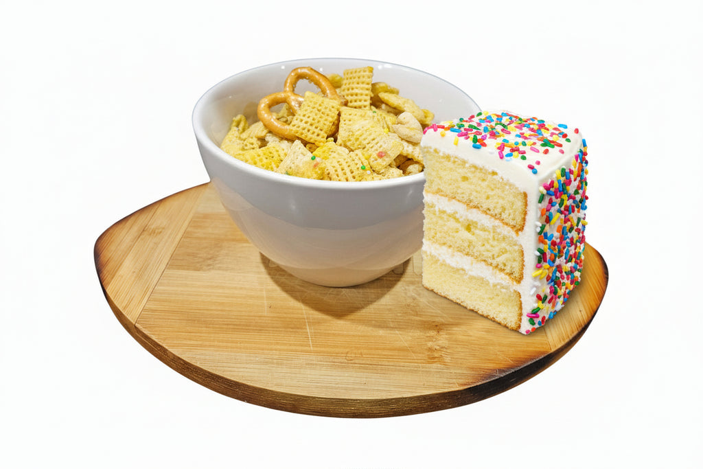 White bowl filled with snack mix on a wooden coaster