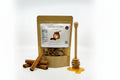 Kraft paper packaging with a label for cinnamon and honey snack mix on a white background