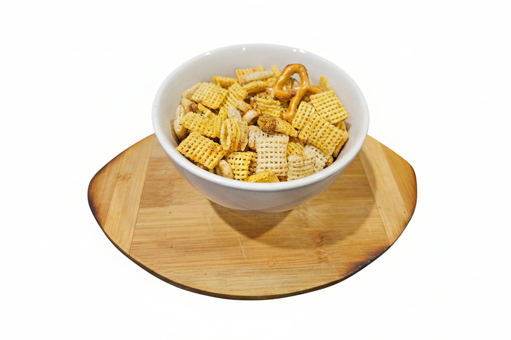 White bowl filled with applewood smoked bbq snack mix on a wooden coaster