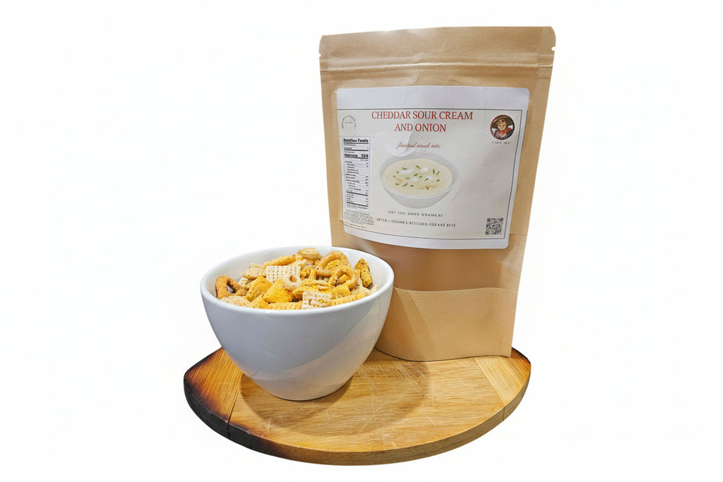 Bag of Cheddar Sour Cream and Onion flavored snack mix next to a bowl of snacks on a wooden tray.
